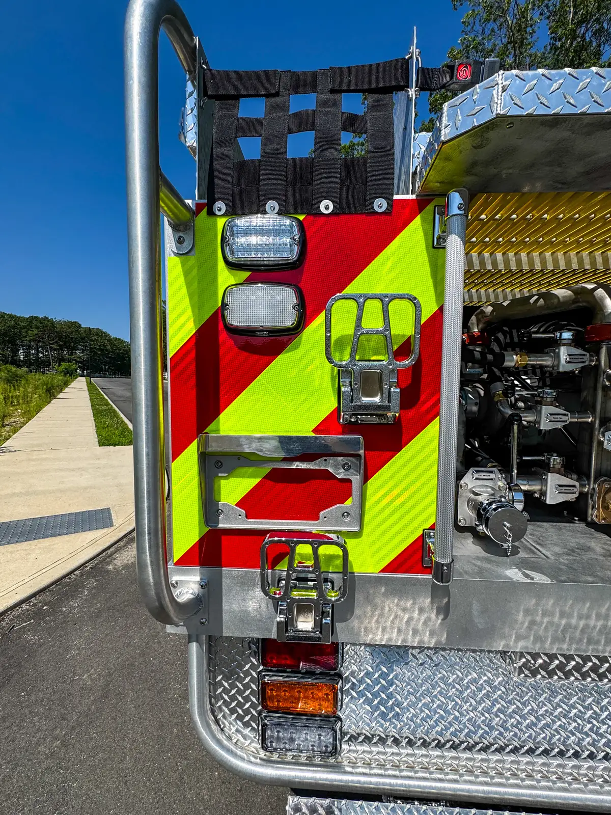 Rear pump compartment open view showing pump assembly, controls, and piping.